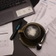 Copywriter's desk with a laptop, coffee and printed drafts
