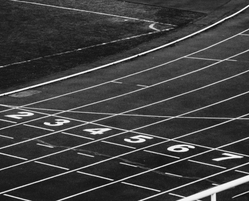 Black and white photo of the starting line on a running track